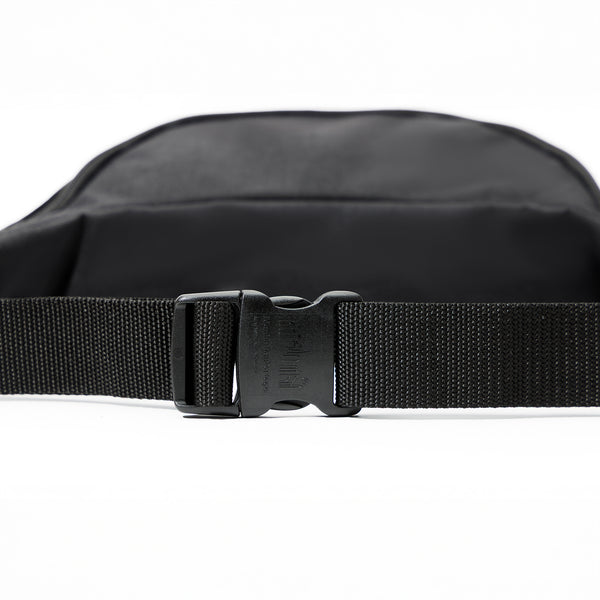 Black waist bag with a buckle on a white background