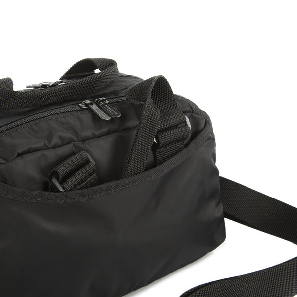Black bag with zippers and straps on a white background