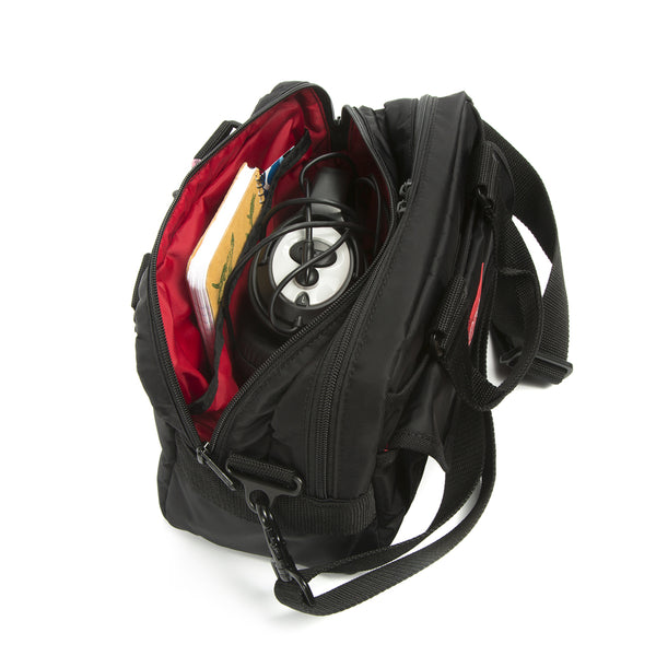 Black backpack with a red interior, containing a black and white object, on a white background